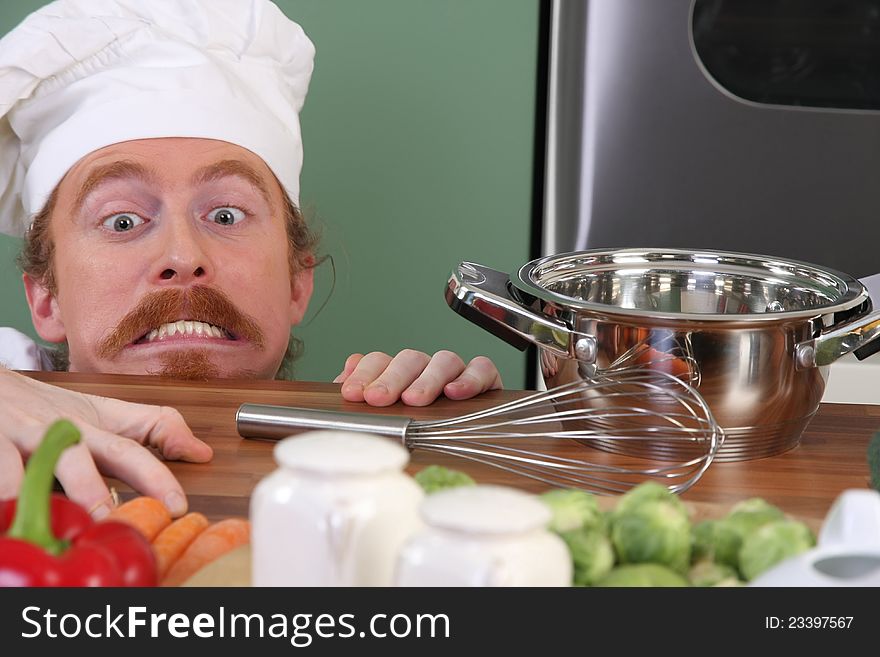 Funny young chef with a pot