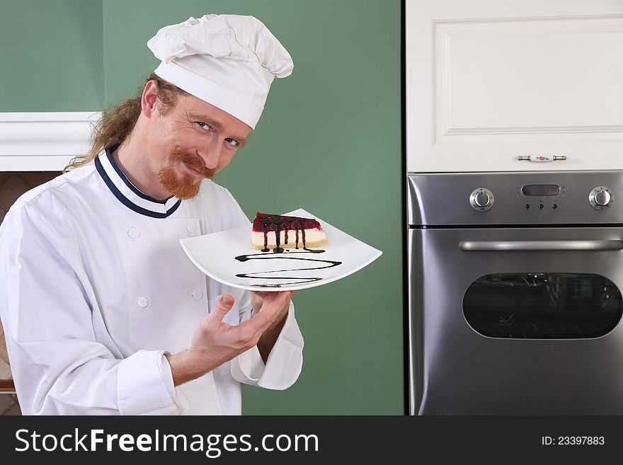 Young chef with piece of cake