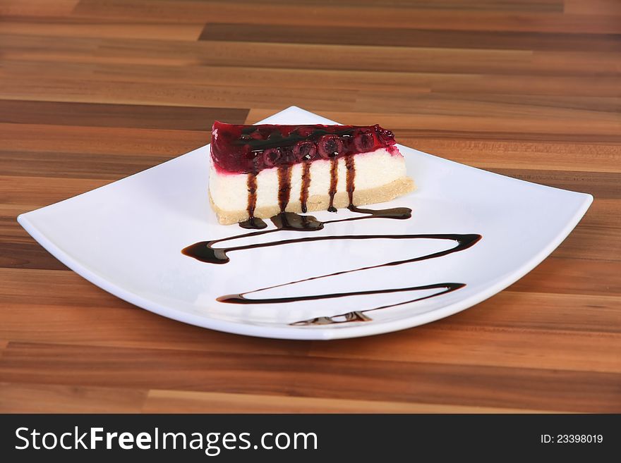 Piece of cake on the plate with chocolate sauce