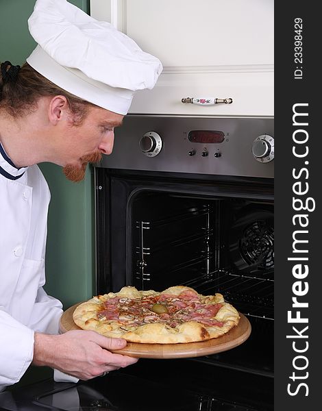 Young chef prepared italian pizza in kitchen. Young chef prepared italian pizza in kitchen