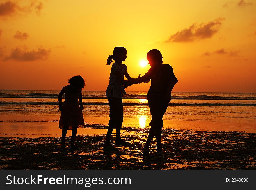 Reflection Silhouetted of three girls watching a boat moves at sunset. Reflection Silhouetted of three girls watching a boat moves at sunset.