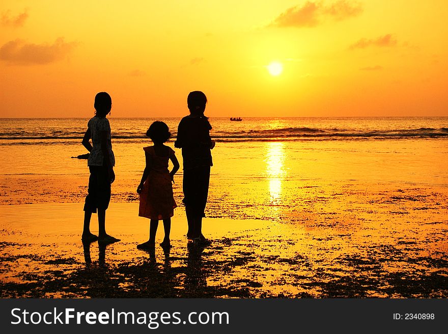 Reflection Silhouetted of three girls watching a boat moves at sunset. Reflection Silhouetted of three girls watching a boat moves at sunset.