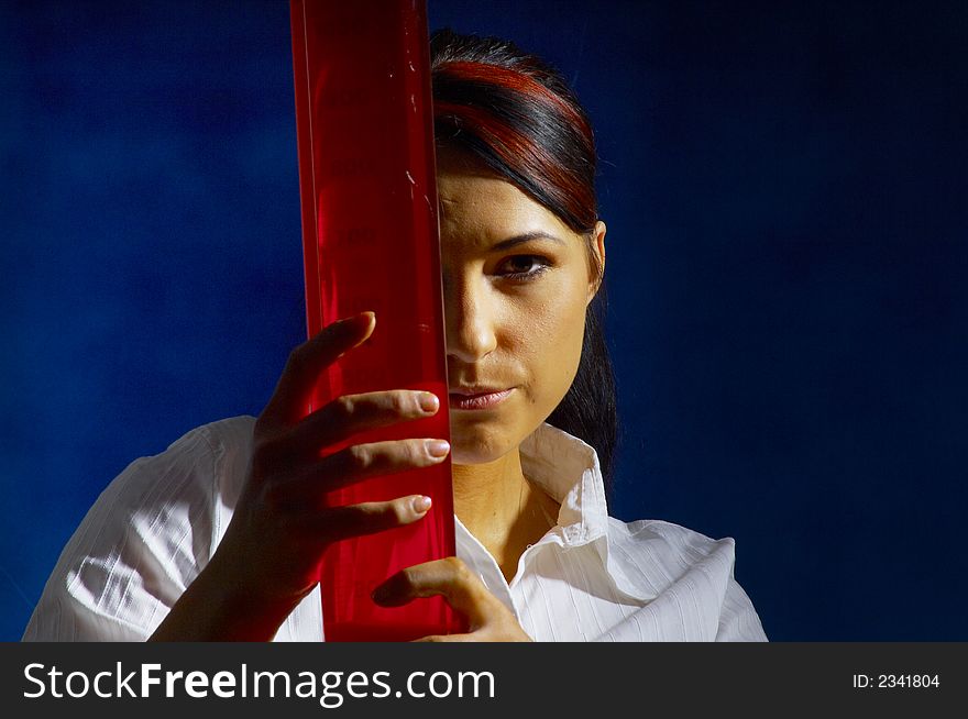 Beautiful female young scientist wearing glasses while doing a blood test