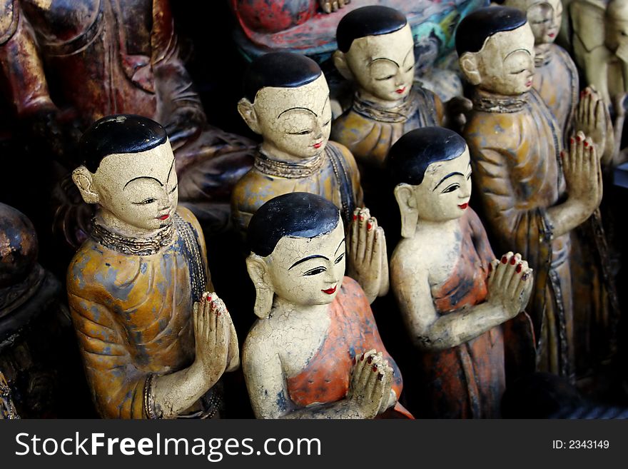 Wooden Buddhist statues in tropical Thailand - travel and tourism