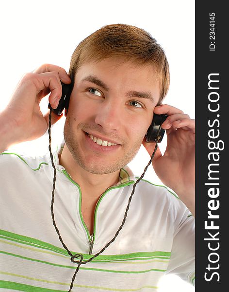Guy listens to music in old headphones, on white background