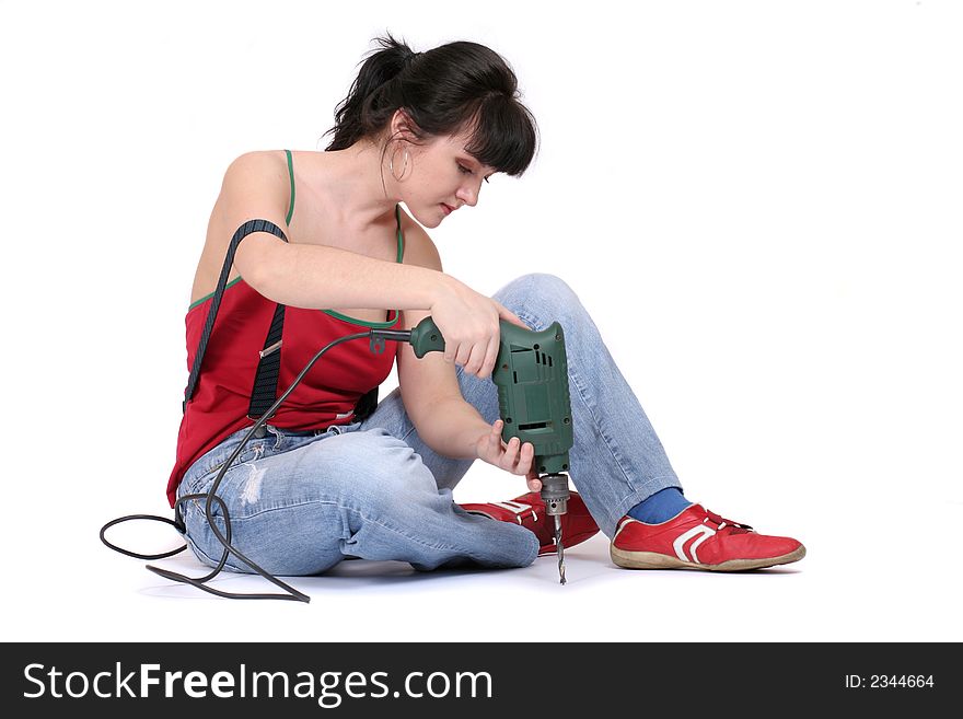 A seriuos woman working with a drill. white background