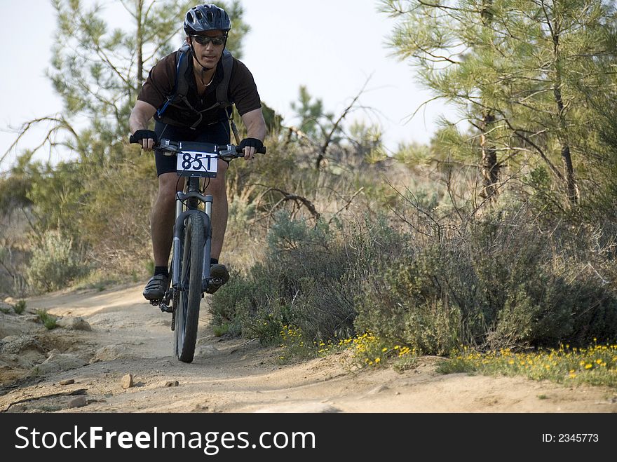 A men on the bike going down hill. A men on the bike going down hill