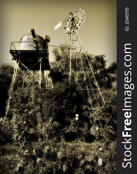 Sepia toned windmill and water tank. Sepia toned windmill and water tank