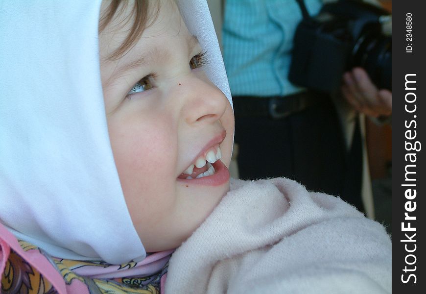 Smiling little girl with head scarf. Smiling little girl with head scarf.