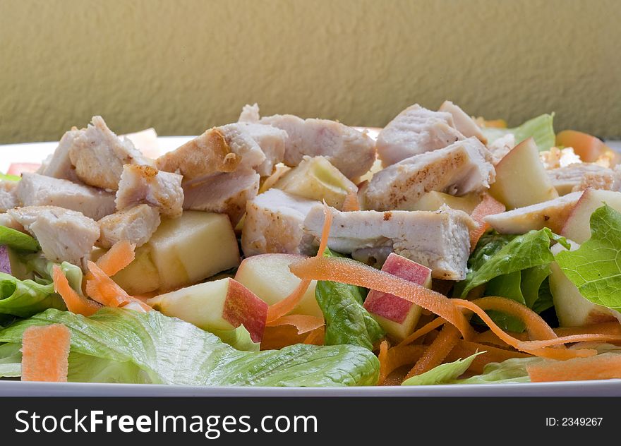 A healthy fast food salad with apple and grilled chicken. A healthy fast food salad with apple and grilled chicken