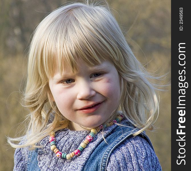 Young blond girl looking thoughtfully. Young blond girl looking thoughtfully