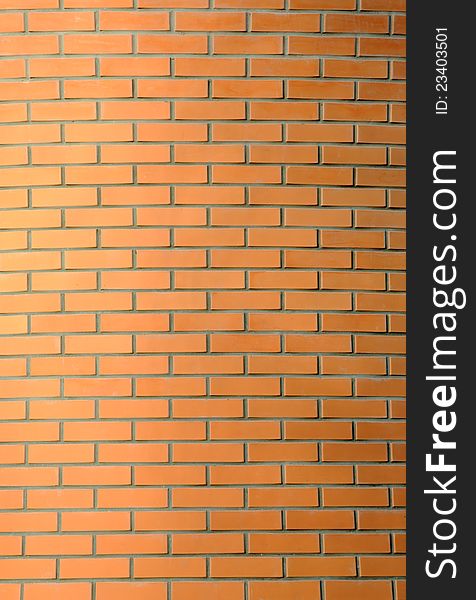 The vertical red brick wall