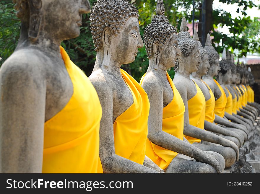 Row of Ruin images of Buddha in Ayutthaya historical park, Thailand