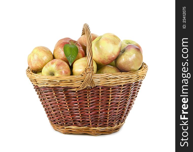 Apples lie in a basket on a white background
