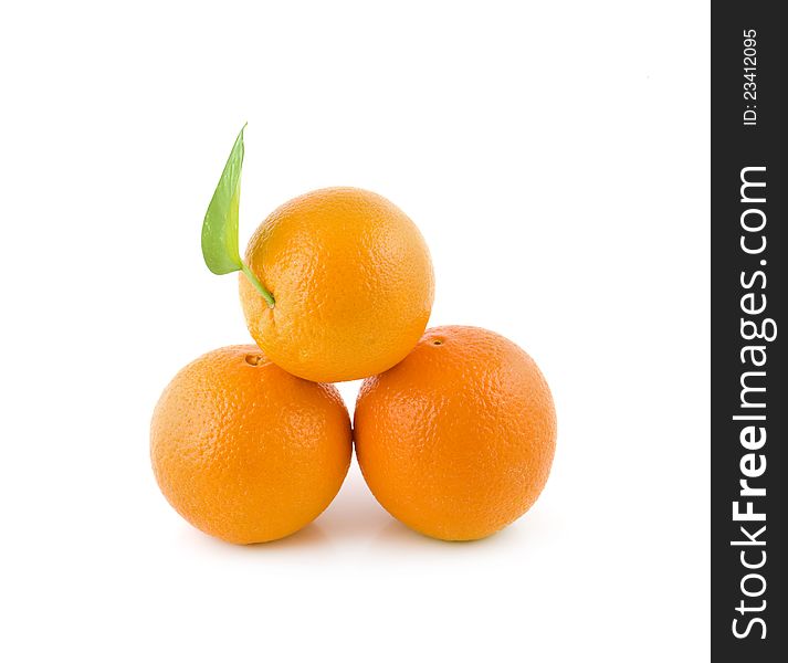 Three oranges lie a small group on a white background