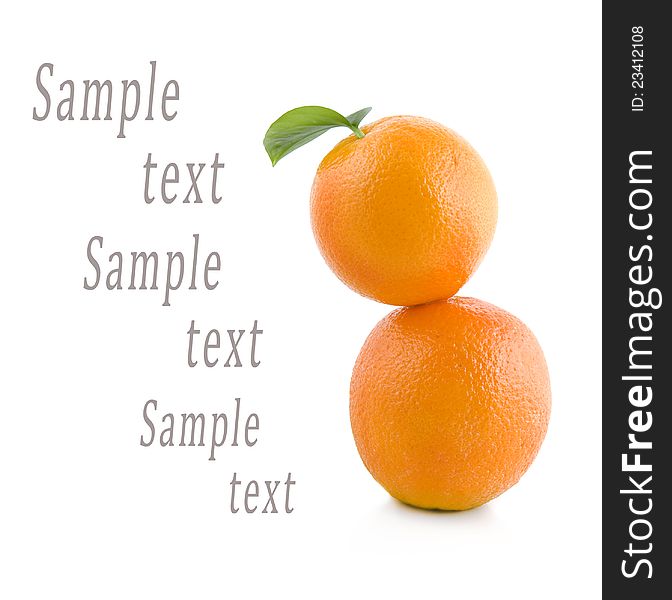 Two oranges stand on each other on a white background