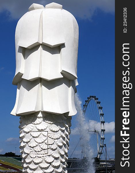 Merlion overlooking the Singapore Flyer at the Esplandade bay. Merlion overlooking the Singapore Flyer at the Esplandade bay