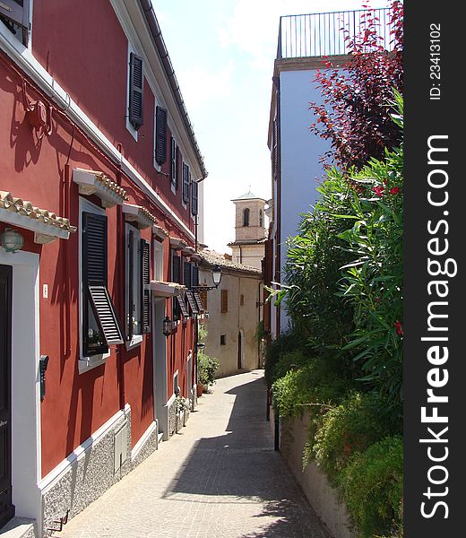 Narrow European street with the red house Italy. Narrow European street with the red house Italy