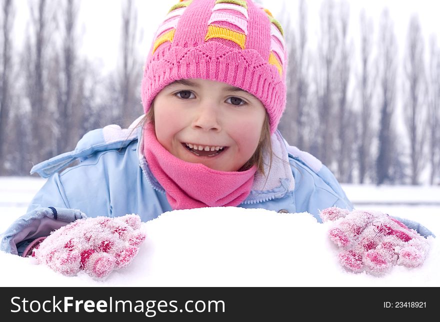 Young girl on the snow winter