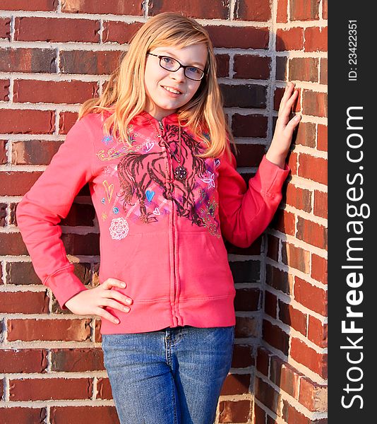 Image of a teenage girl posing by red bricks. Image of a teenage girl posing by red bricks