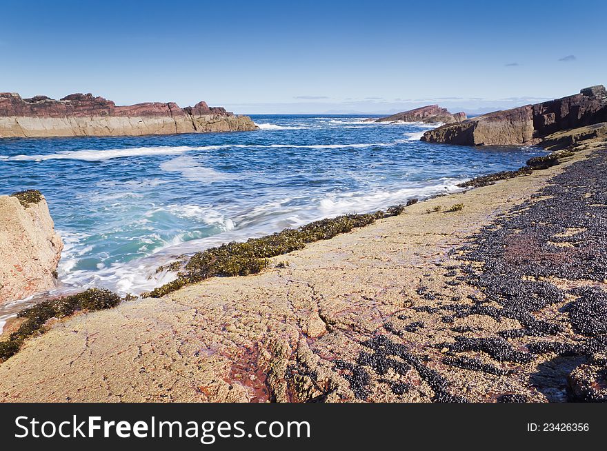 Seascape on a sunny day with rugged coastline. Seascape on a sunny day with rugged coastline