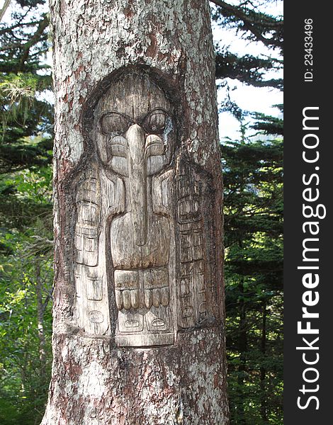 Sculpture depicting a bird on the bark of an old pine tree in Alaska. Sculpture depicting a bird on the bark of an old pine tree in Alaska