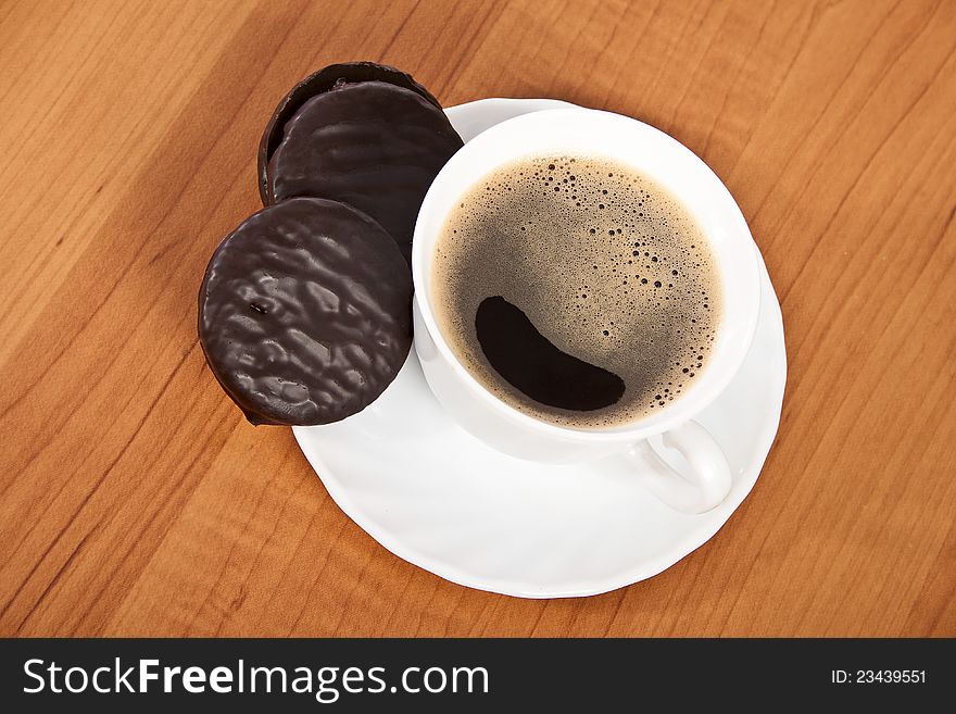 Cup of coffee and chocolate cookies on wooden table. Cup of coffee and chocolate cookies on wooden table