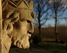 Stone Head Overlooking Churchyard Stock Photography Stone Head Overlooking Churchyard Stock Photography