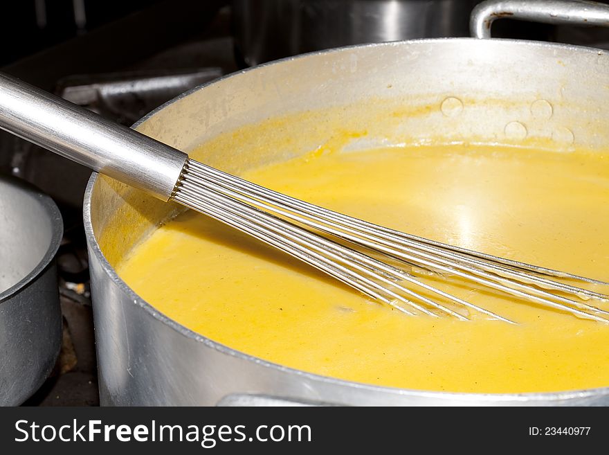 Cooking a vegetable soup in a kitchen fire