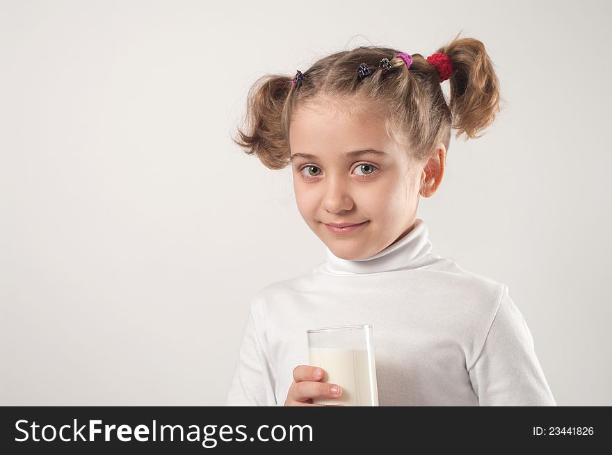 Cute little girl drinks milk