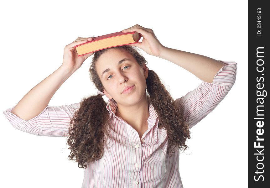 Young student girl with her books in hand at head, smiling and looking at the camera
