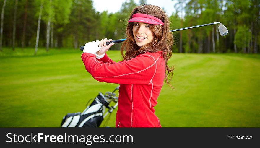 Portrait of a woman playing golf on a green