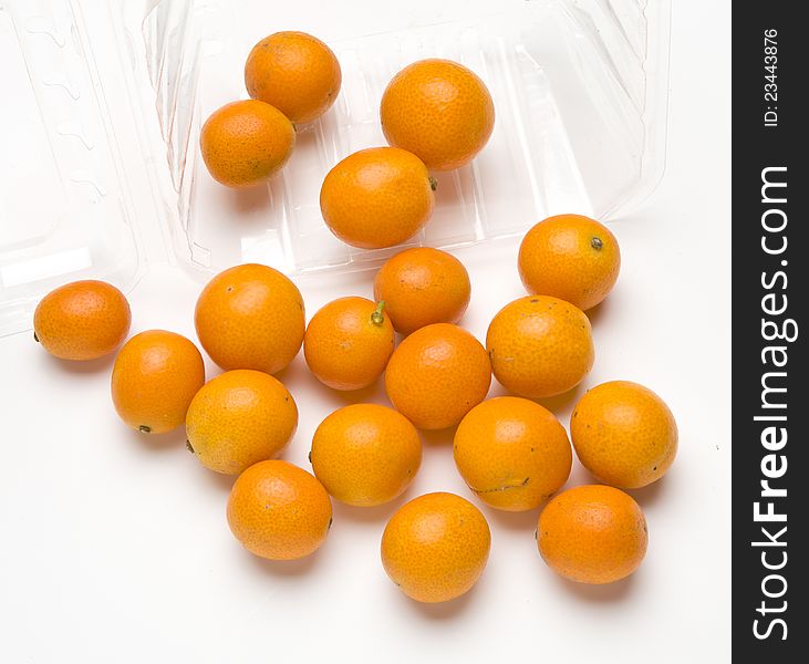 Fresh ripe kumquats photographed on white background