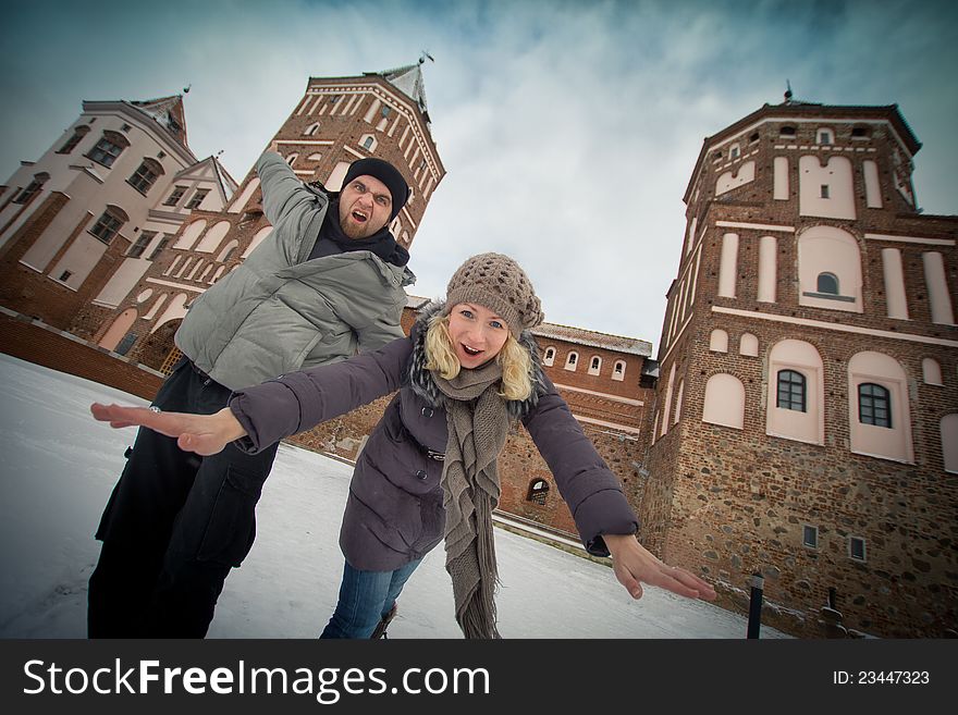 Traveling couple in love at the walls of the ancient castle