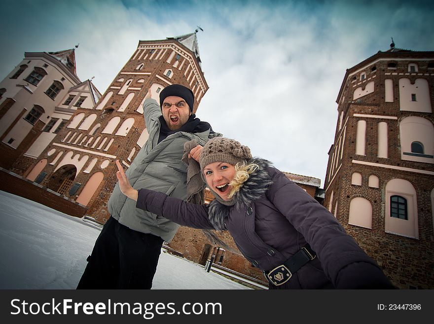 Traveling couple in love at the walls of the ancient castle