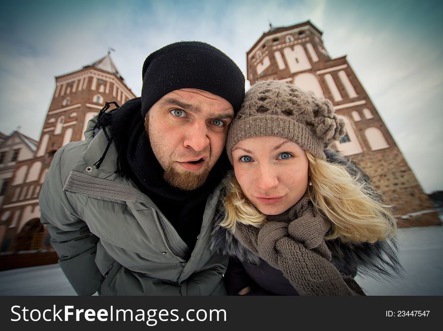 Traveling couple in love at the walls of the ancient castle