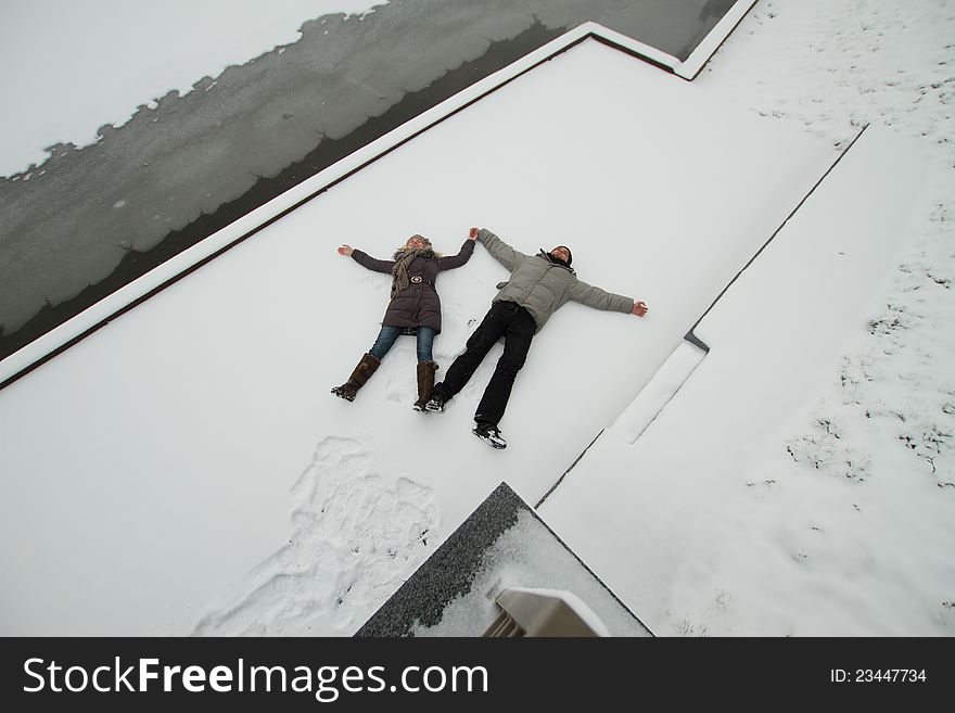 A young couple in love having fun in the snow. A young couple in love having fun in the snow