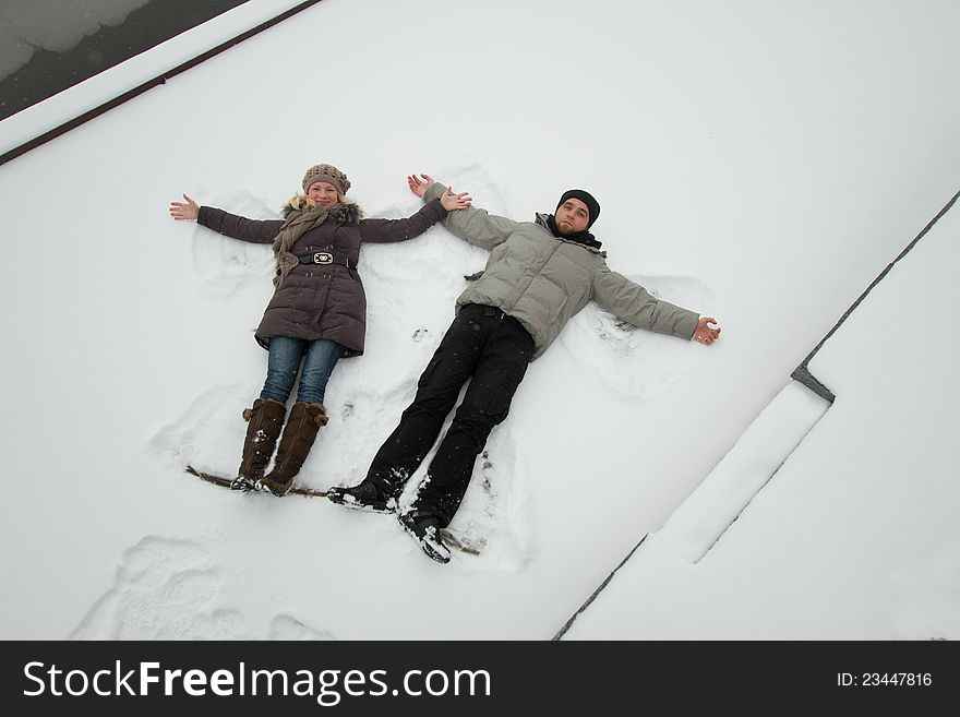 A young couple in love having fun in the snow. A young couple in love having fun in the snow