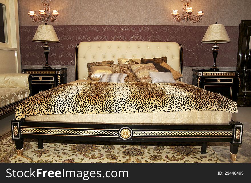 Beautiful bedroom with huge bed and a leopard blanket