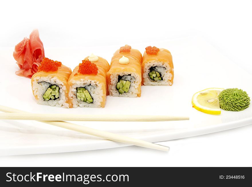 Sushi on a plate with chopsticks in a restaurant