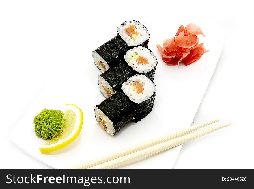 Sushi on a plate with chopsticks on a white background