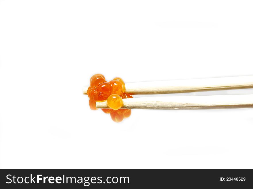 Eggs on the chopsticks on a white background. Eggs on the chopsticks on a white background