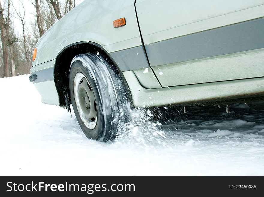 The car rides on snowy roads