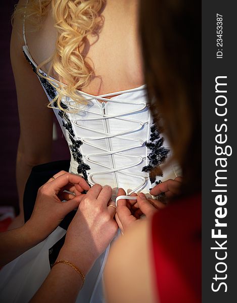 Tying corset bride