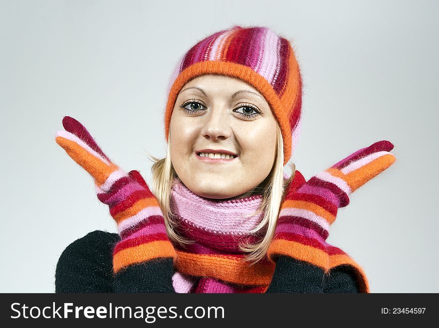 Beautiful girl in a hat and gloves on the background