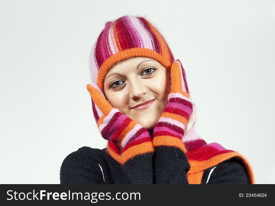 Beautiful girl in a hat and gloves, holding a person in the background