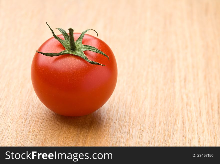 Ripe red tomato on the wood