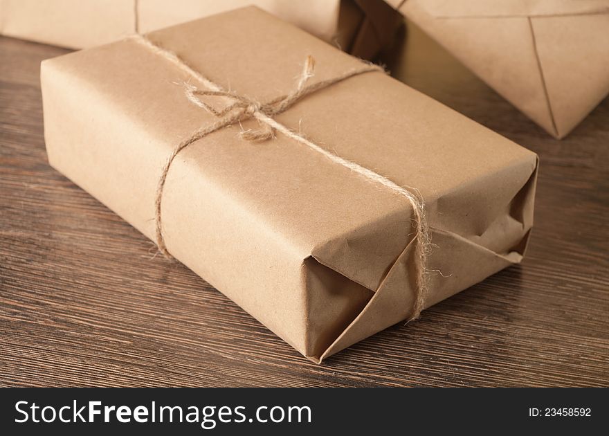 Pile parcel wrapped with brown kraft paper and tied with twine. Pile parcel wrapped with brown kraft paper and tied with twine