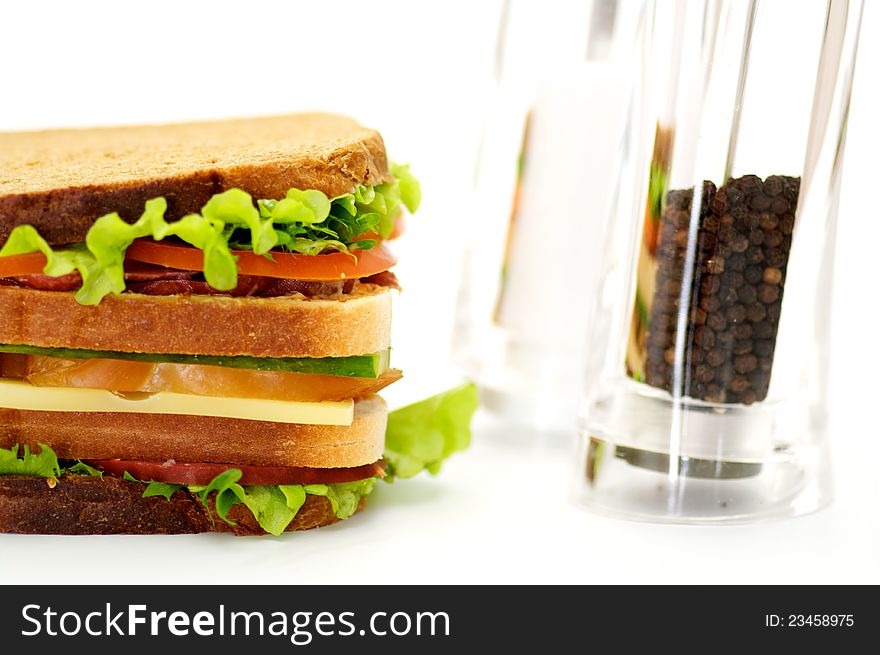 Classical BLT Club Sandwich with Saltcellar and pepperbox isolated on white background