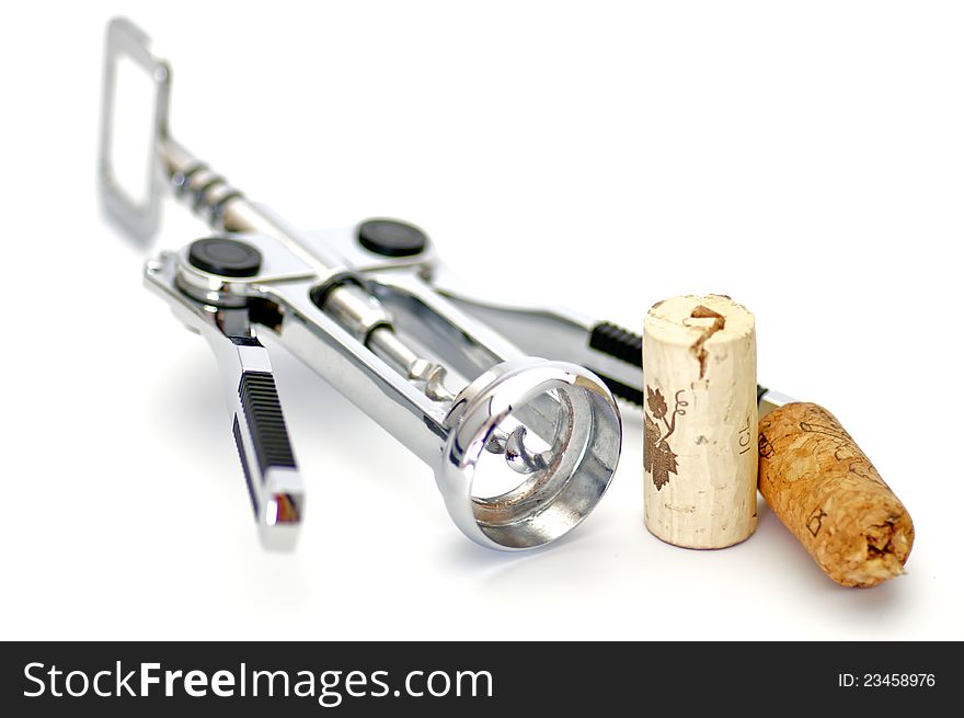 Corkscrew and two wine corks isolated on white background